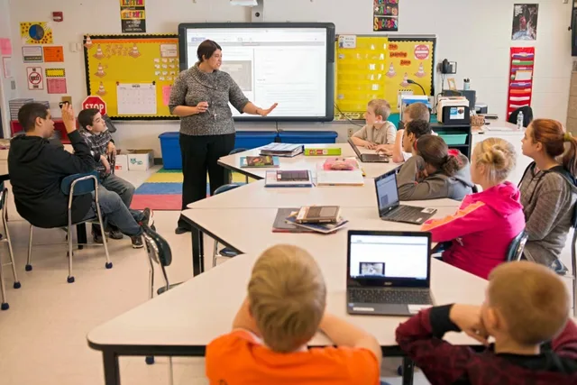 Sixth-grade teacher Carrie Young guides her students through an exercise on their laptops as practice for the the Common Core State Standards Test in Stockport, Ohio, Feb. 12, 2015. Your teen's school laptop: filters, monitoring, alerts