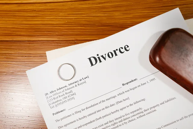 Close-up of a divorce document and wedding ring on a lawyer's desk. What happens when eight vague clauses in family agreements get rewritten?