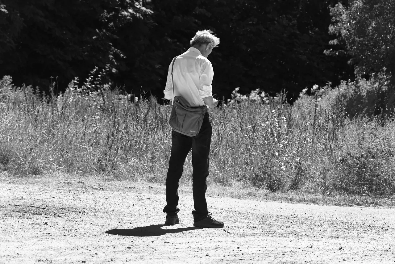 person, man, people, alone, solitary, standing, checking phone, footpath, outdoors, sunny day, white shirt, editorial, disney. Screen-time habits examples compared: the parts worth your attention, updated for 2027